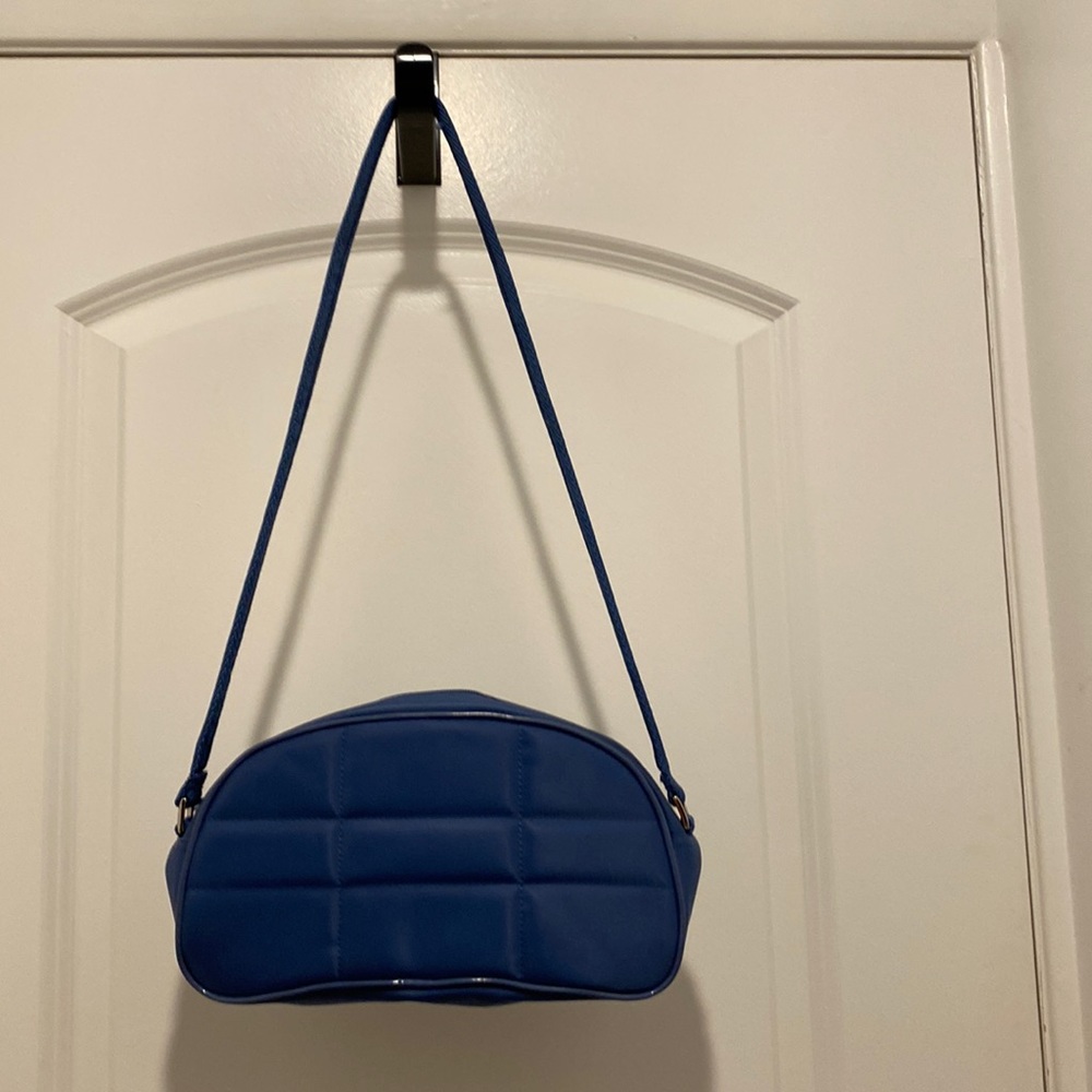 Small vinyl slightly quilted compact handbag. Strap 34” width 10“ depth 5 1/2”